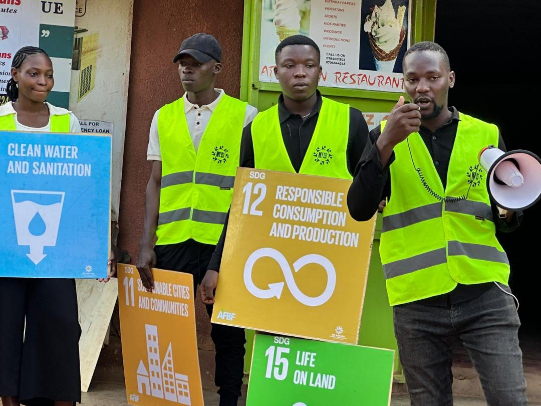 Volunteers with SDG 11, 12 and 15 signs