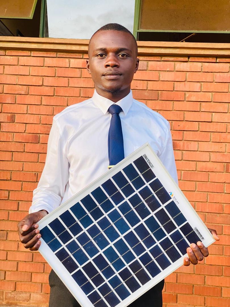 A young advocate holding a solar panel